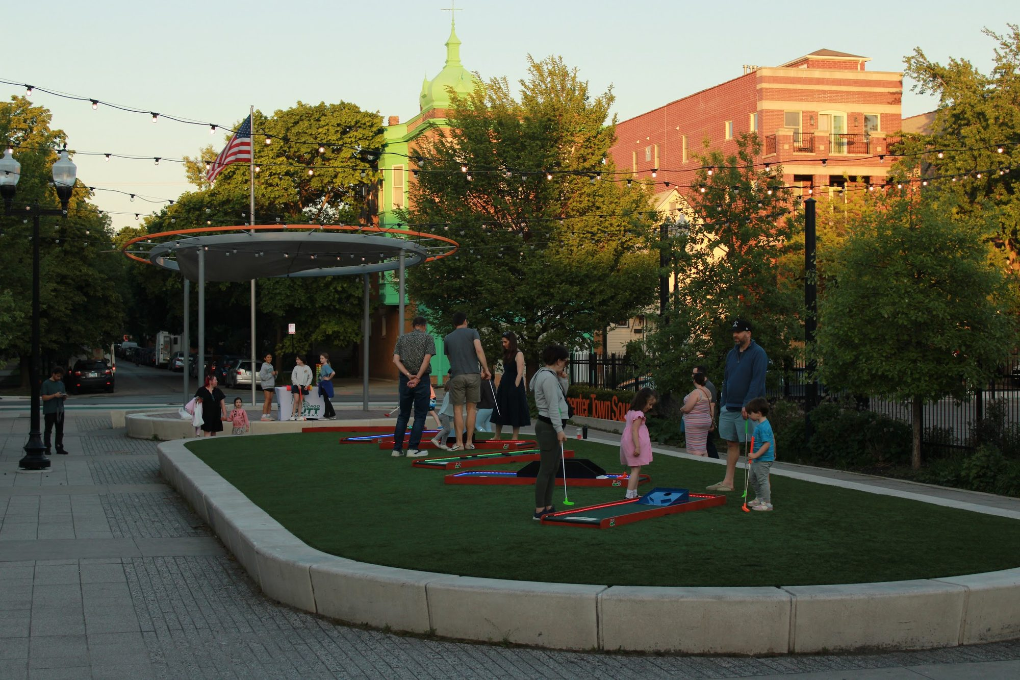 An evening mini golf event with players on the course