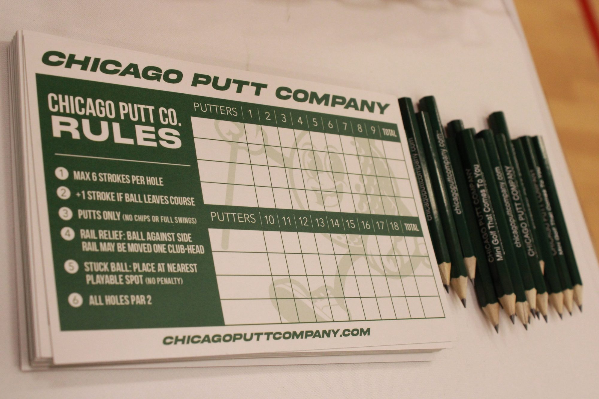 Custom branded Chicago Putt Company scorecards and pencils